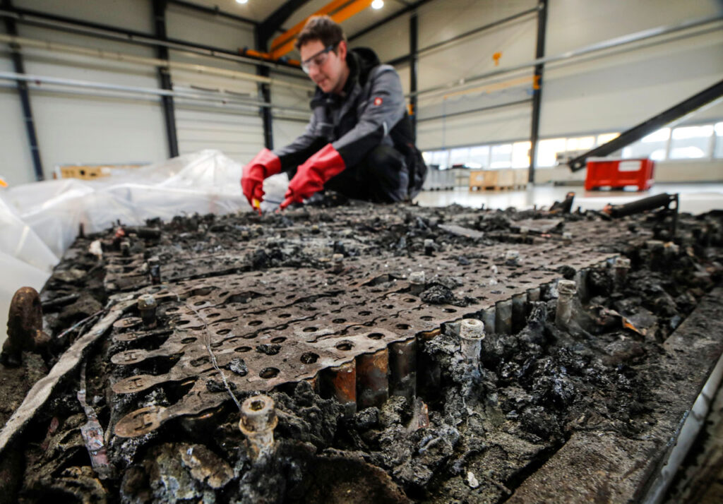 A burned lithium-ion battery is discharged before further recycling.